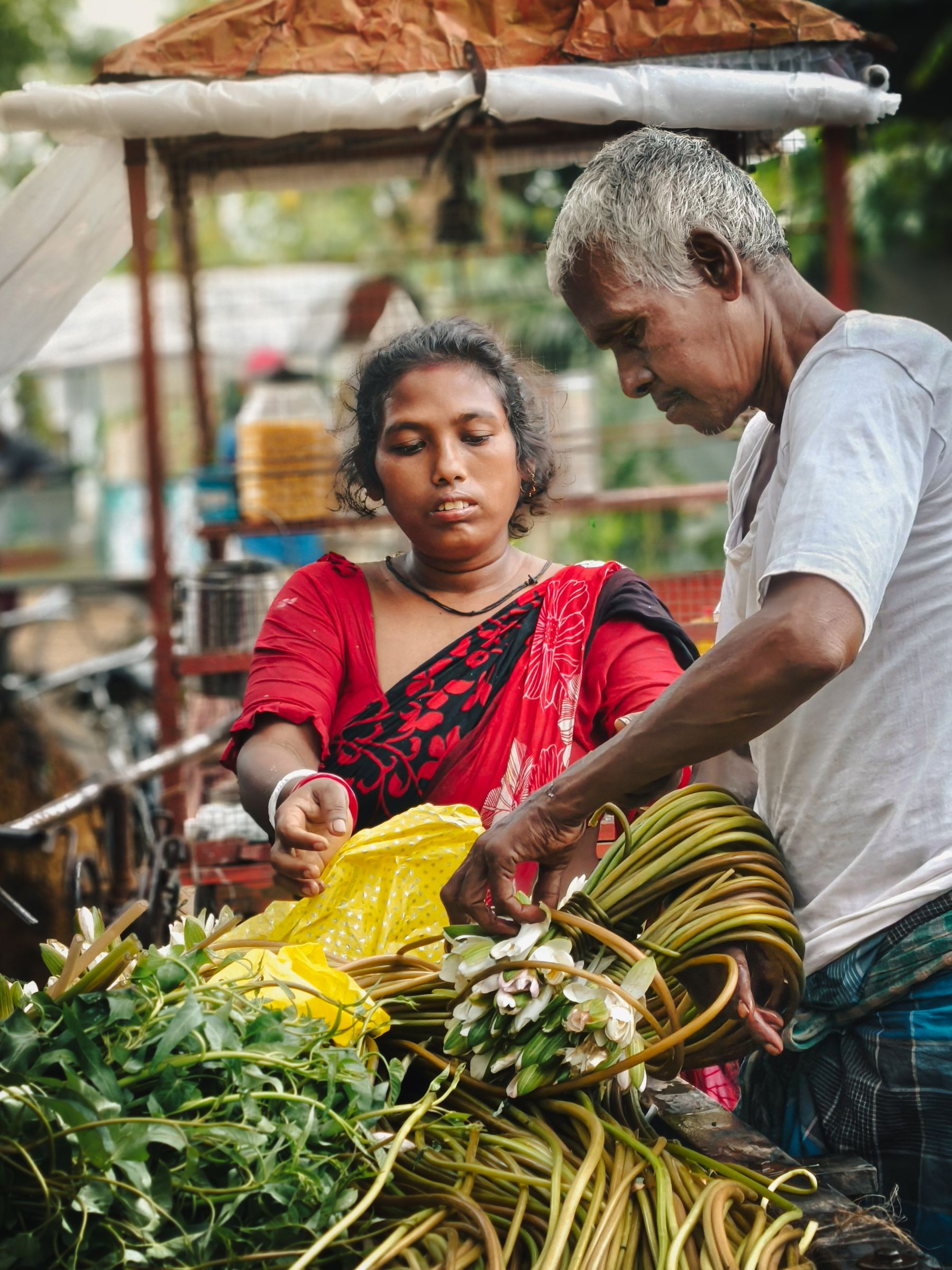 Two local market operators sorting fresh produce together