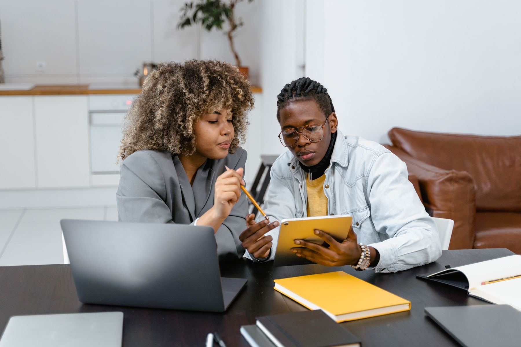 Two business operators reviewing a plan together on a tablet