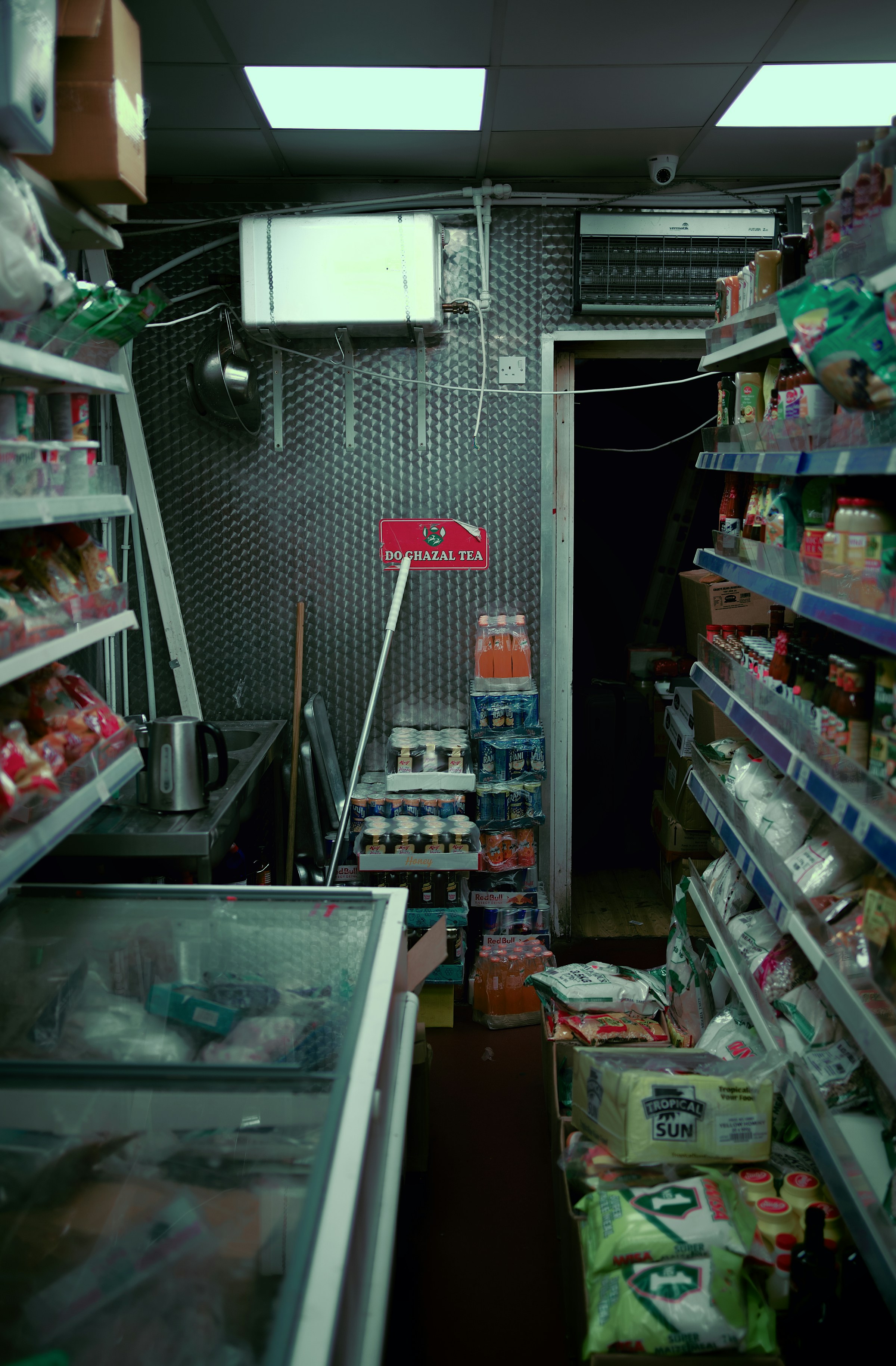Shelves stocked with everyday products inside a neighborhood convenience store