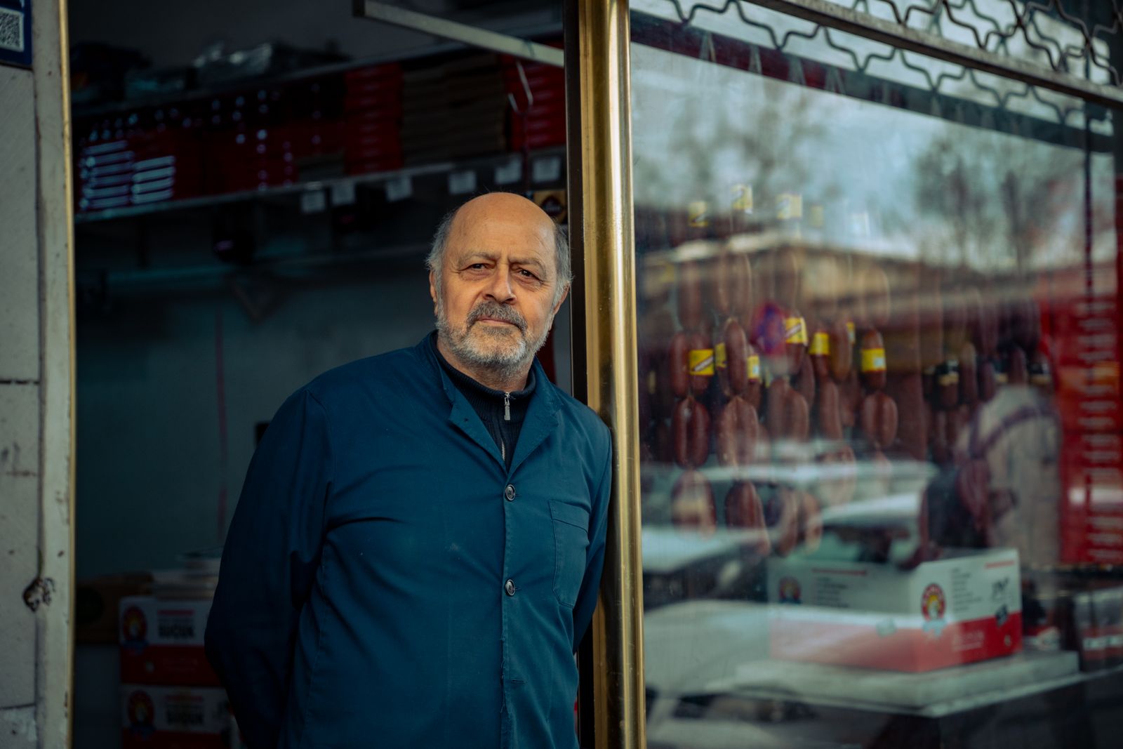 A retail operator standing between shelves in a neighborhood store