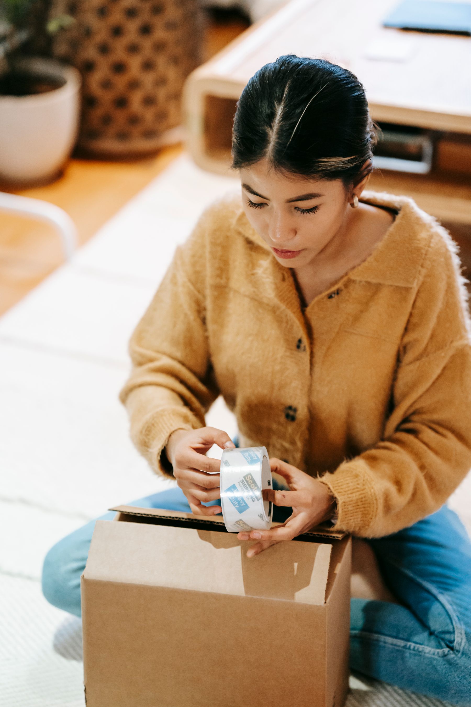 A parcel being sealed carefully before dispatch