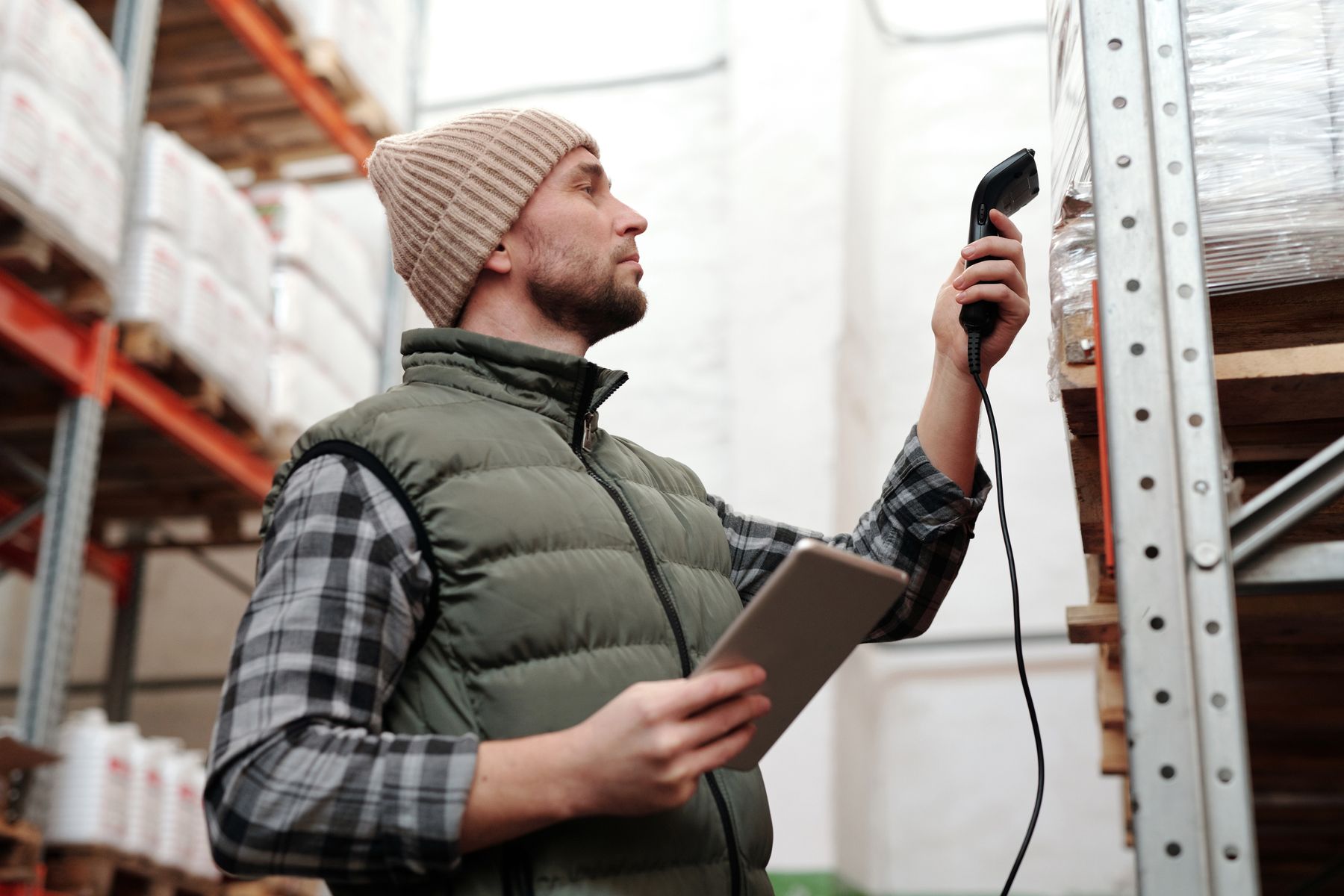 Worker scanning incoming goods in a stock area