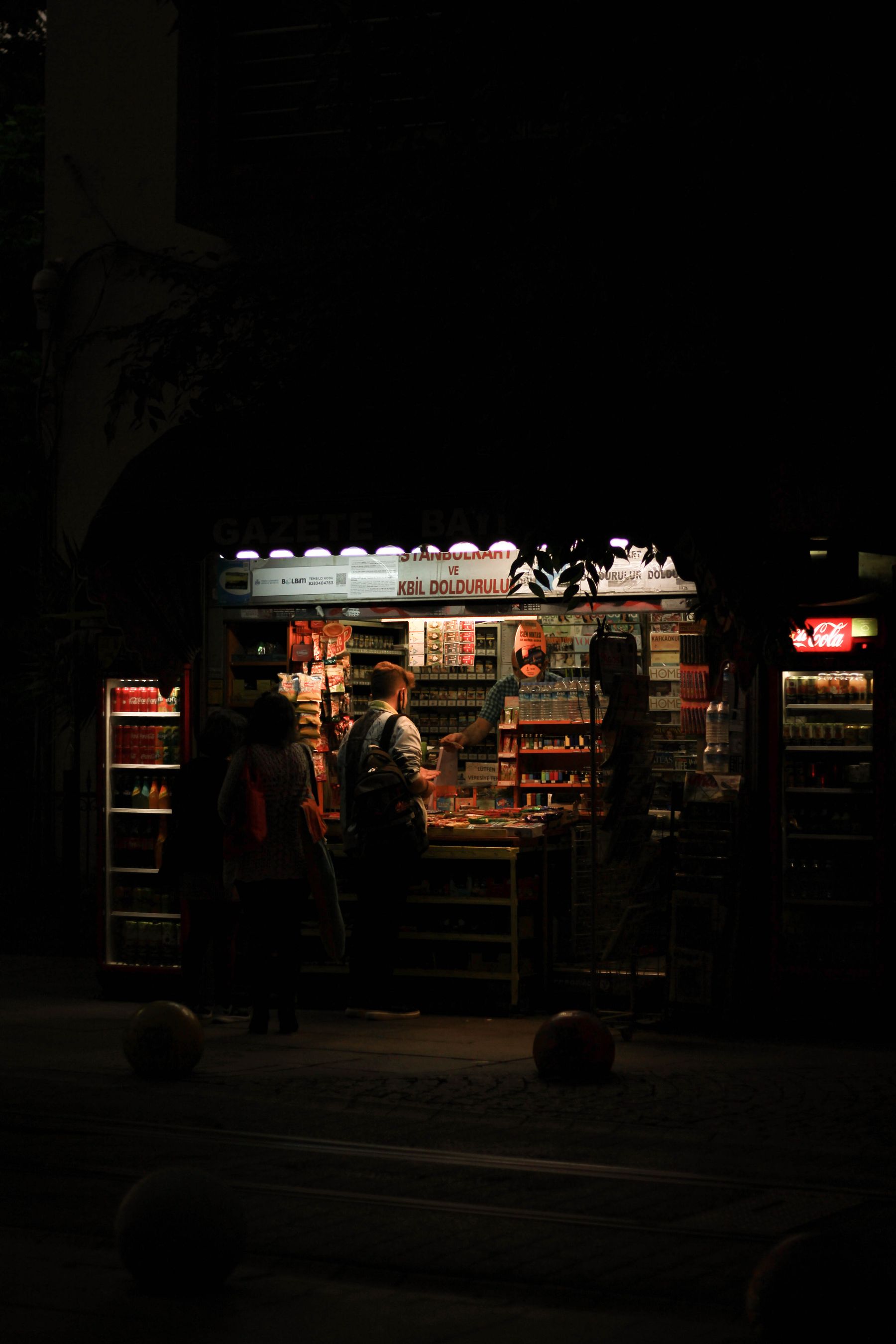 A neighborhood convenience store illuminated after dark